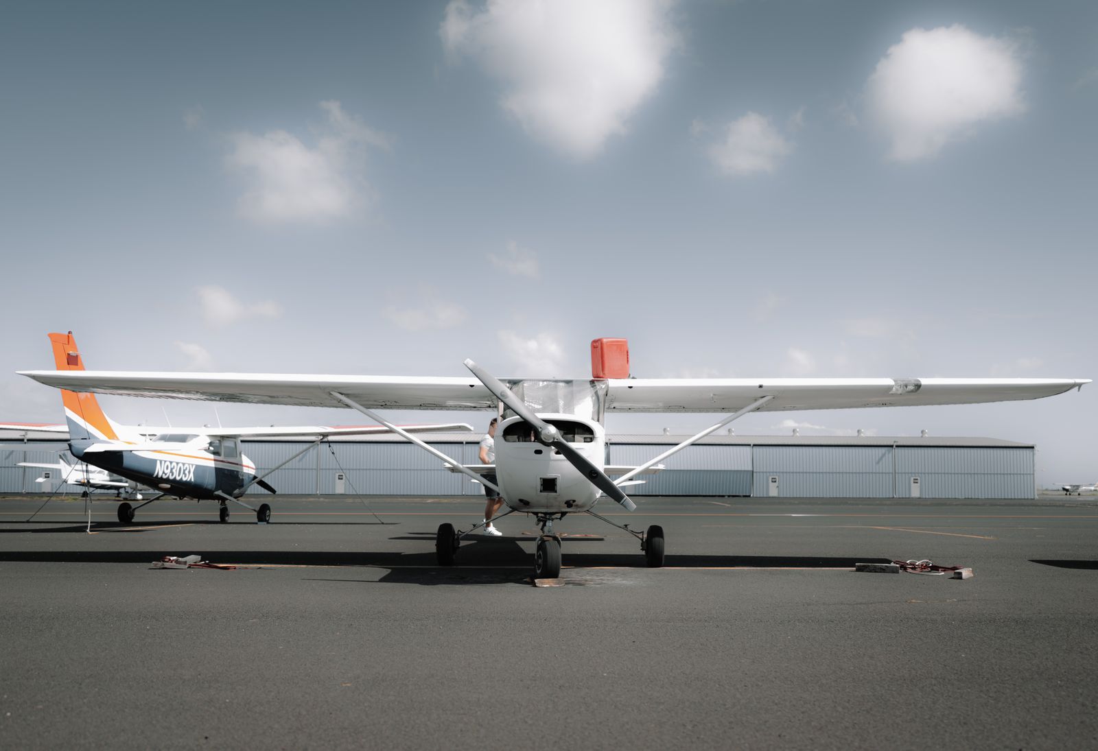 Modern propeller aircraft parked on a sunlit aerodrome